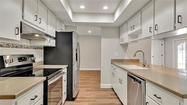 kitchen featuring white cabinets, backsplash, sink, and appliances with stainless steel finishes