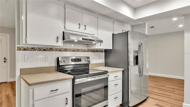 kitchen with decorative backsplash, white cabinetry, light hardwood / wood-style flooring, and stainless steel appliances