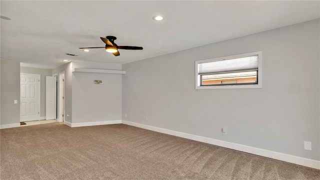 empty room featuring ceiling fan and carpet floors