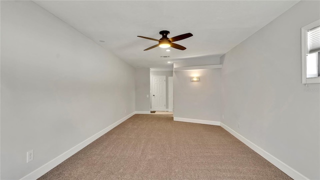 carpeted empty room featuring ceiling fan