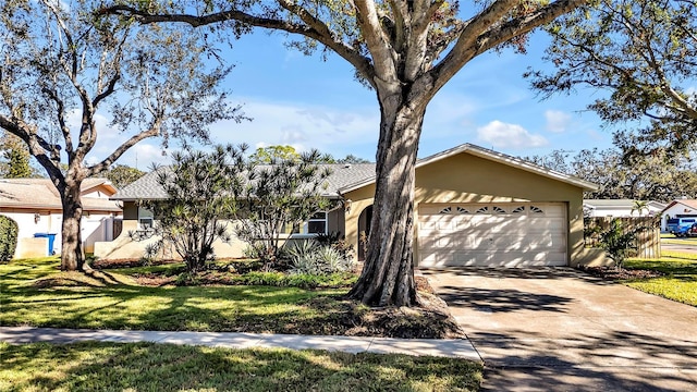 ranch-style house with a garage and a front lawn