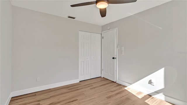 spare room featuring light hardwood / wood-style flooring and ceiling fan