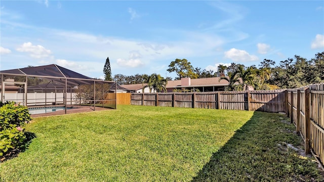 view of yard with glass enclosure