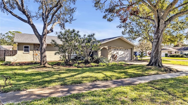 ranch-style home featuring a garage and a front lawn