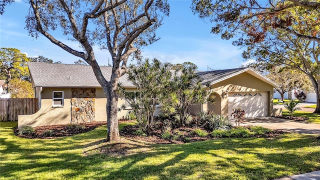 ranch-style house featuring a garage and a front yard