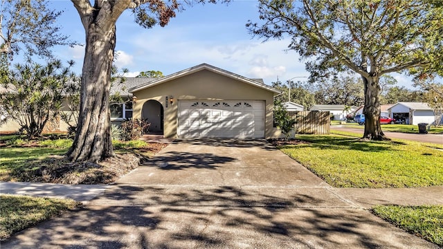 ranch-style house featuring a front lawn and a garage