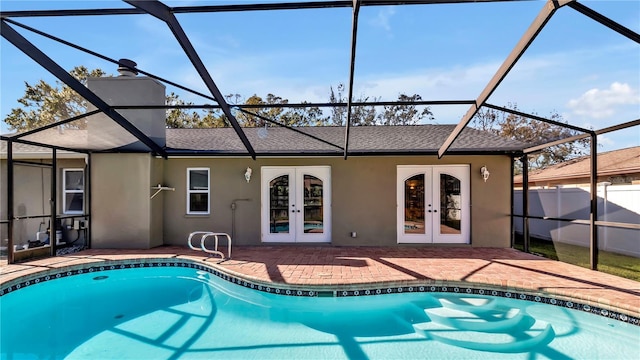 view of swimming pool with french doors, a lanai, and a patio area