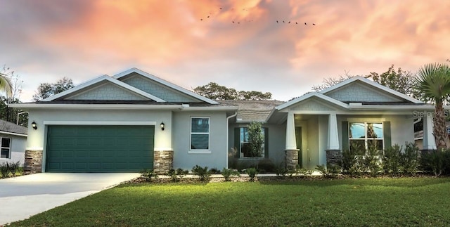 craftsman house with a garage and a yard