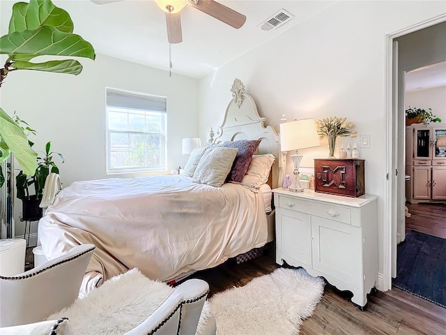 bedroom featuring ceiling fan and dark wood-type flooring