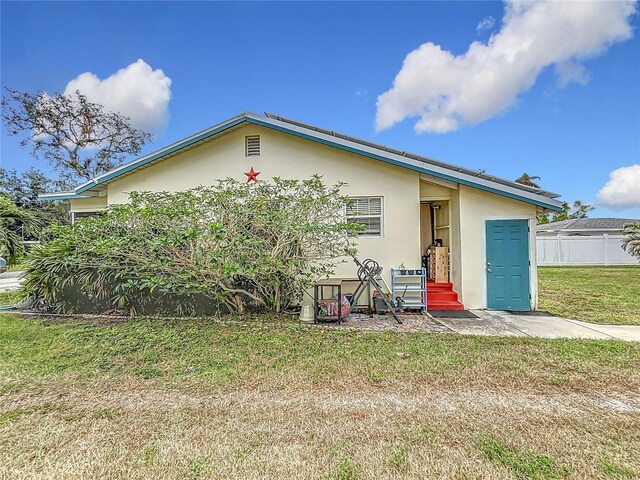 rear view of house with a lawn