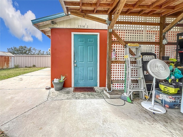 view of exterior entry featuring a patio