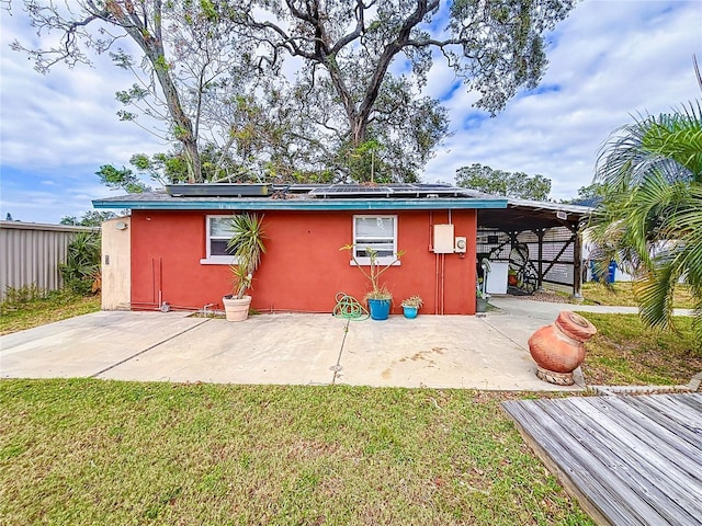 view of outbuilding featuring solar panels and a yard