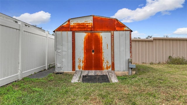 view of outbuilding featuring a lawn