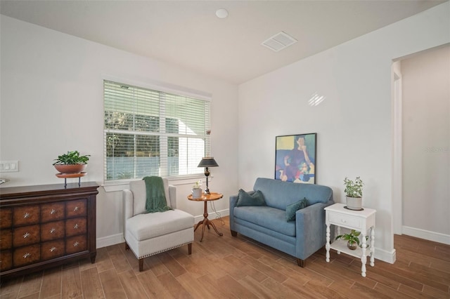 living area with hardwood / wood-style flooring