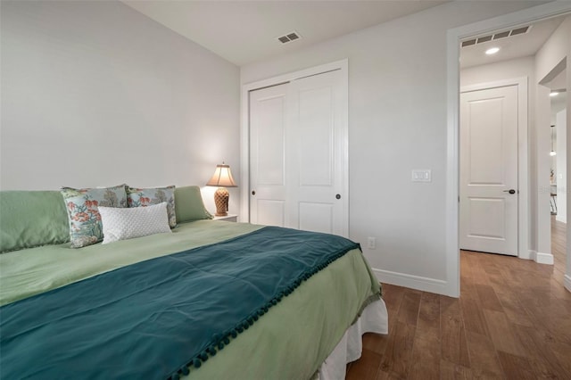 bedroom with a closet and hardwood / wood-style flooring