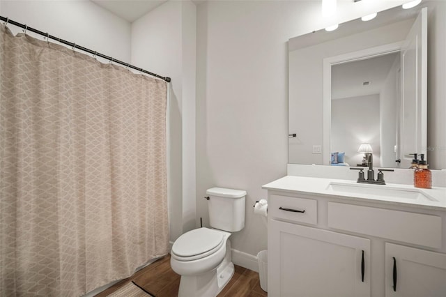 bathroom with vanity, toilet, and wood-type flooring