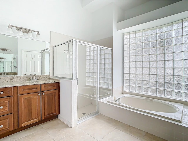 bathroom with tile patterned flooring, vanity, and separate shower and tub