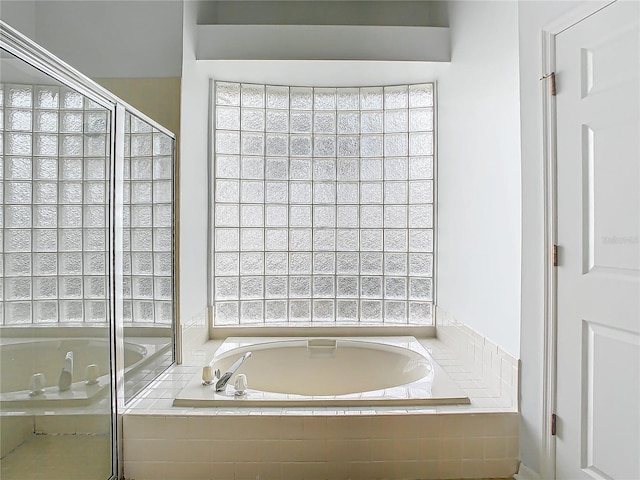 bathroom with tiled bath