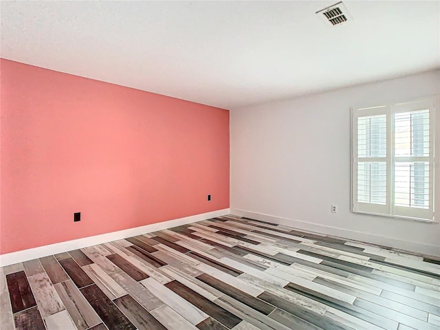 empty room featuring wood-type flooring