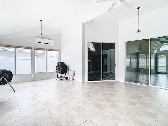 interior space with vaulted ceiling, a wealth of natural light, ceiling fan, and a wall unit AC