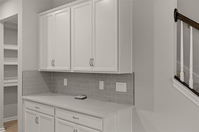 kitchen featuring white cabinetry and tasteful backsplash