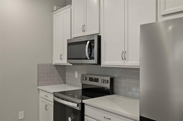 kitchen featuring white cabinetry, appliances with stainless steel finishes, and backsplash