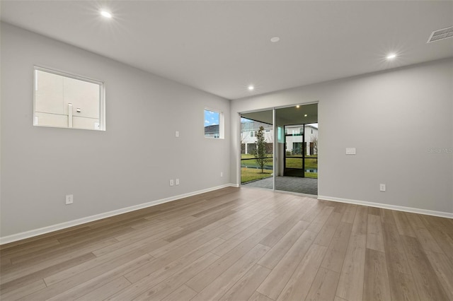 spare room featuring light hardwood / wood-style floors