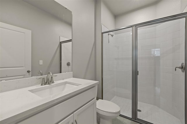 bathroom featuring vanity, toilet, and an enclosed shower