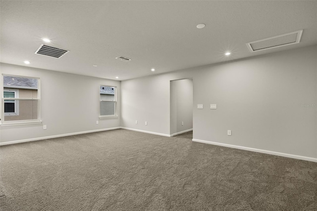 unfurnished room with dark carpet