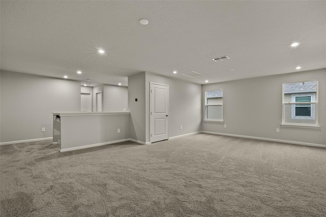 carpeted spare room featuring a textured ceiling