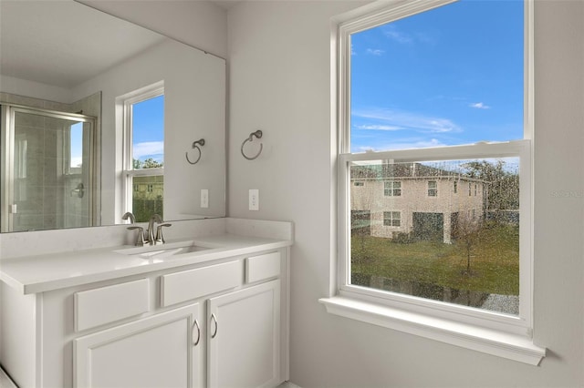 bathroom featuring vanity and a shower with shower door