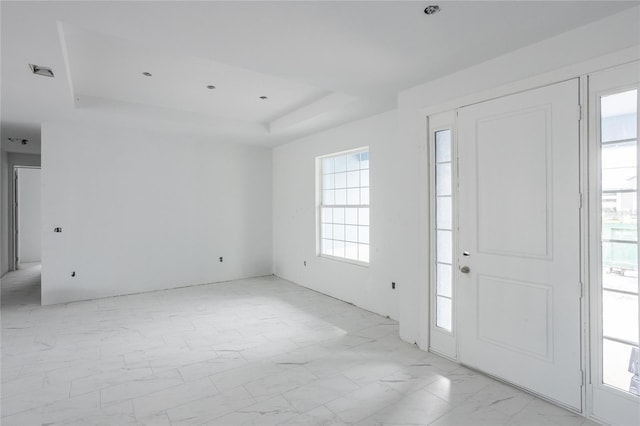 entryway with a raised ceiling