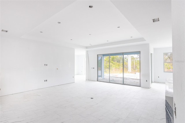 empty room featuring a tray ceiling