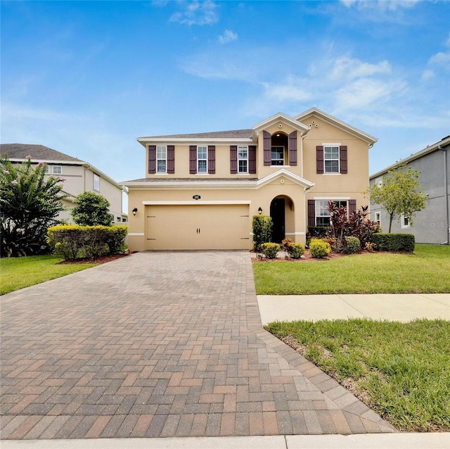 front of property featuring a garage and a front lawn