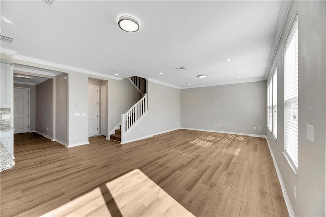 unfurnished living room featuring light hardwood / wood-style floors and crown molding