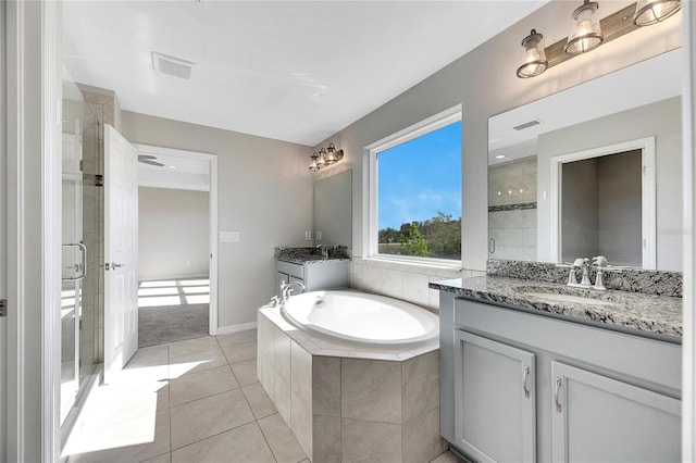 bathroom featuring tile patterned flooring, vanity, and separate shower and tub