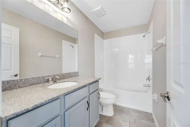 full bathroom featuring tile patterned floors, a textured ceiling, toilet, vanity, and tiled shower / bath