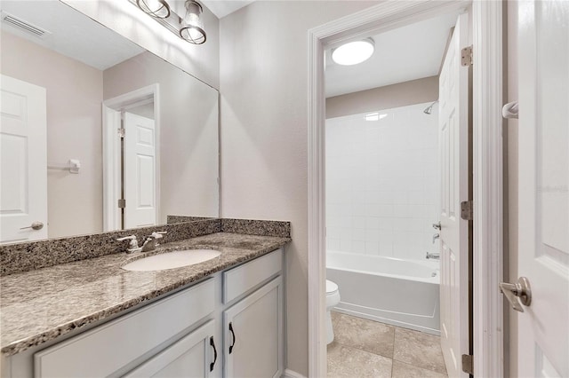 full bathroom featuring vanity, tiled shower / bath combo, and toilet