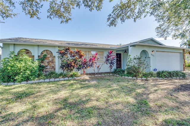 ranch-style home featuring a garage and a front yard