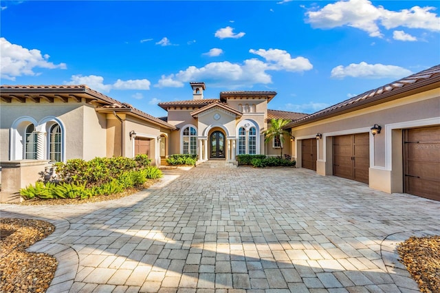 mediterranean / spanish-style house featuring a garage