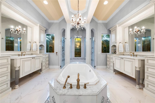 bathroom featuring tiled tub, vanity, crown molding, and a chandelier