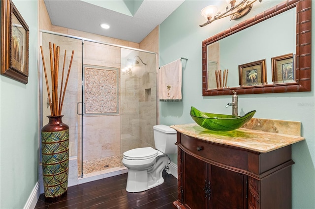 bathroom with toilet, vanity, and walk in shower