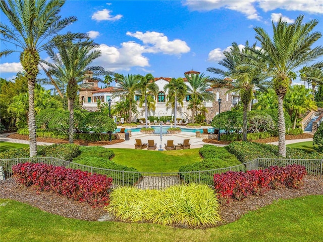 surrounding community featuring a lawn and a swimming pool