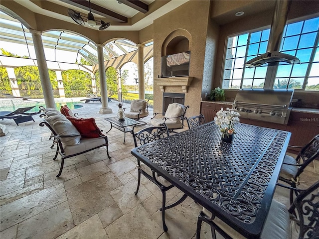 view of patio featuring area for grilling, a grill, glass enclosure, and an outdoor fireplace