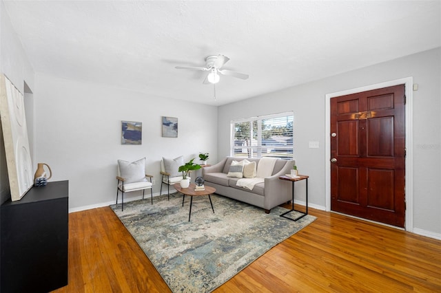 living room featuring hardwood / wood-style flooring and ceiling fan