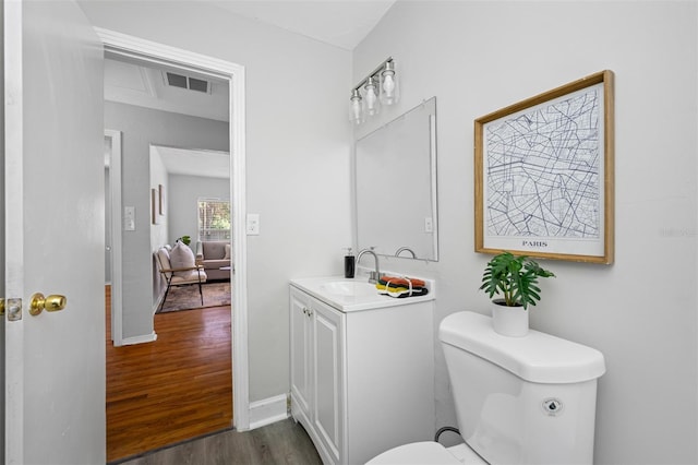 bathroom featuring vanity, toilet, and wood-type flooring