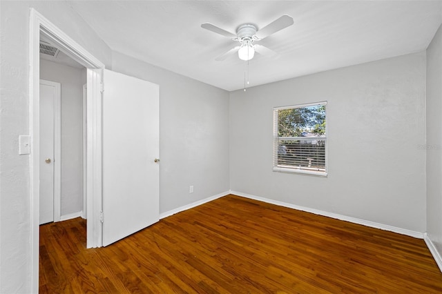 empty room featuring dark hardwood / wood-style floors and ceiling fan