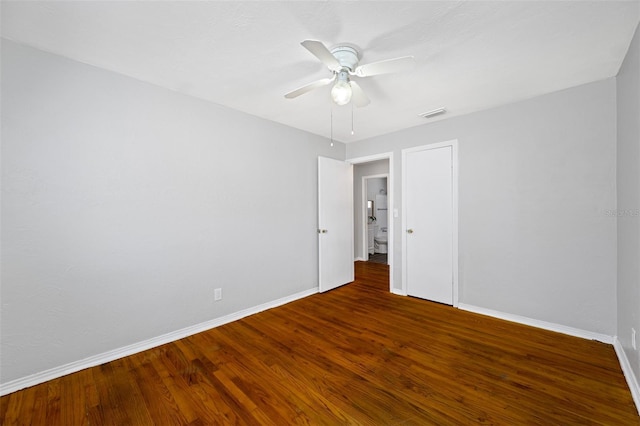 spare room with ceiling fan and dark hardwood / wood-style flooring