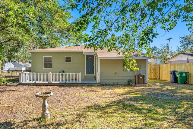 ranch-style house featuring a front lawn and central AC