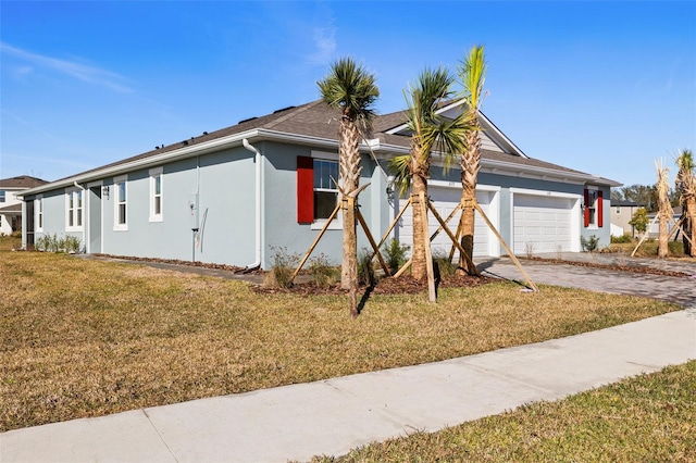 ranch-style home featuring a garage and a front lawn